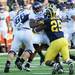 Michigan linebacker Kenny Demens tackles Northwestern running back Tyris Jones on fourth down to end overtime with Michigan beating Northwestern 38-31 at Michigan Stadium on Saturday. Melanie Maxwell I AnnArbor.com